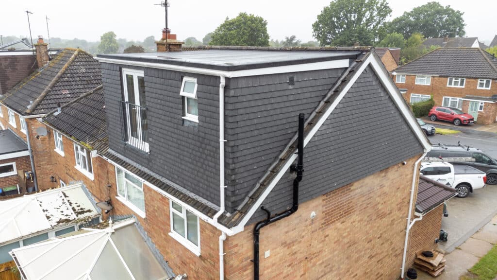Flat roof repair specialists at work on a flat roof in Mid Sussex by Cornerstone Roofing